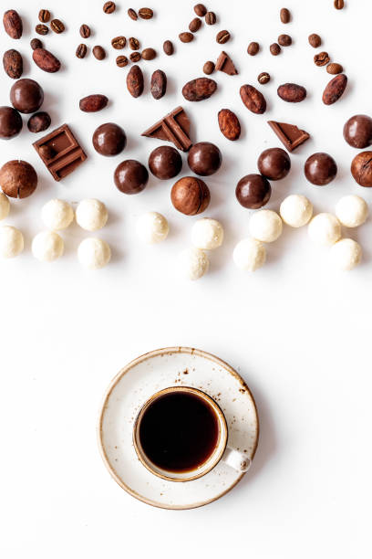 istock Candy background with chocolate and coffee on white background top view pattern 1225553173