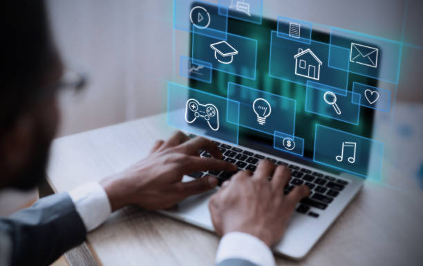 istock African American businessman working on his laptop in office, selecting functional icon from virtual interface, collage 1225553205