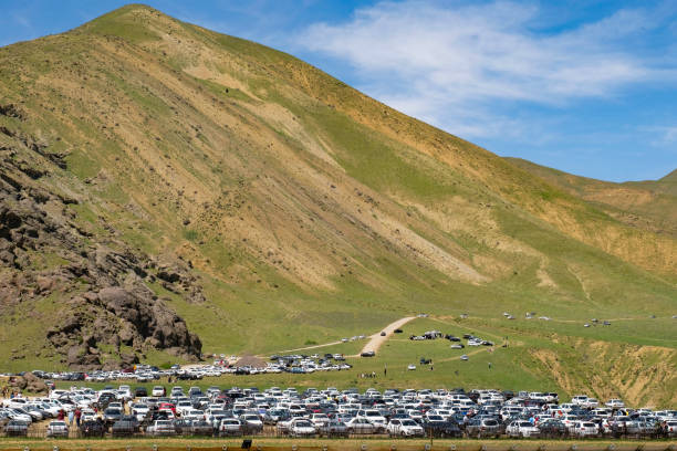 Natural parking lot at green foothills of the mountain hosts hikers, campers, and climbers It's weekend and people have parked their cars in a natural parking lot at green foothills of Alborz mountain for hiking. This area is located in the north of Tehran and has a beautiful landscape. foothills parkway photos stock pictures, royalty-free photos & images