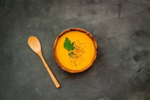 istock Pumpkin cream soup on grey table top view. Autumn traditional meal 1225553346