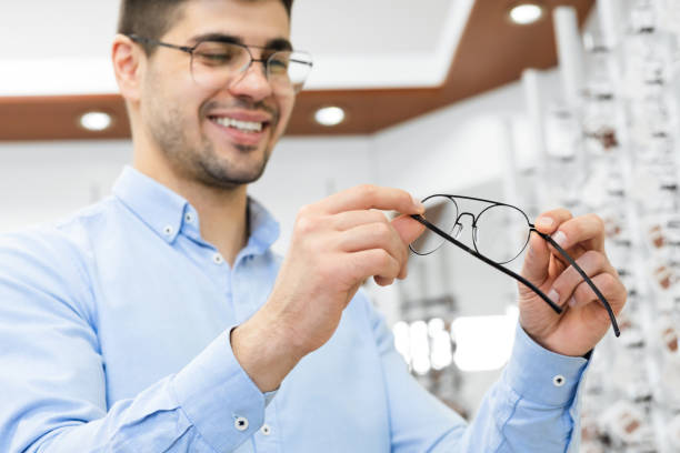 istock Portrait of handsome young guy choosing spectacles 1225553395