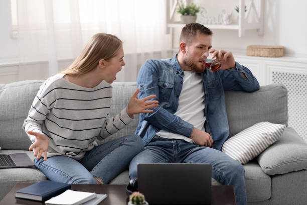 istock Desperate woman arguing with drunk husband at home 1225553441