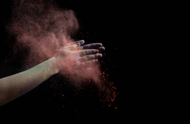 istock Clap hands during Holi. Red cloud of dry paint 1225554426