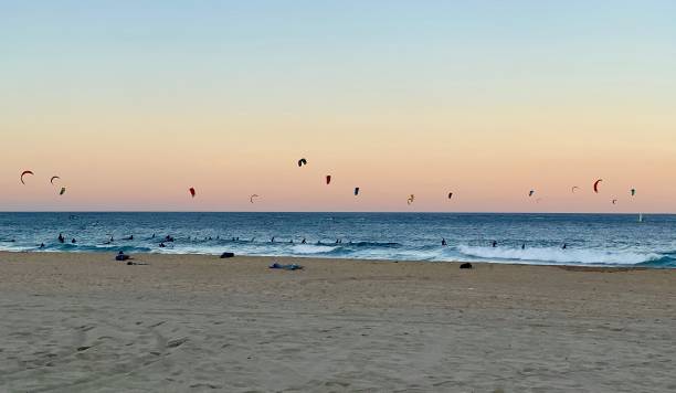 Kitesurfing sunset Sea full of skitesurfers during sunset at Barcelona beach kiteboarding stock pictures, royalty-free photos & images