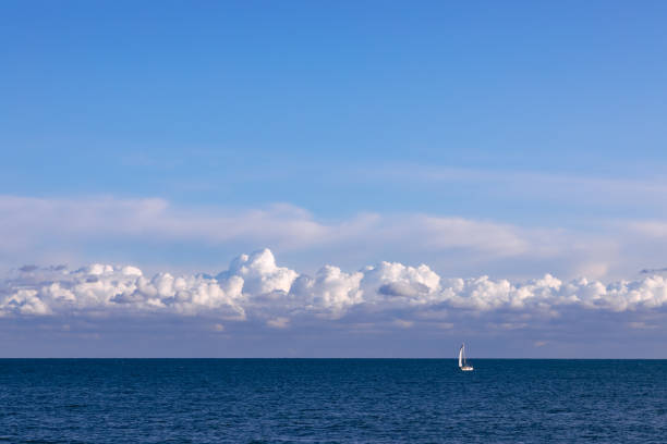 istock Stunning seascape with sailing boat and evening sky with textured clouds. 1225556481