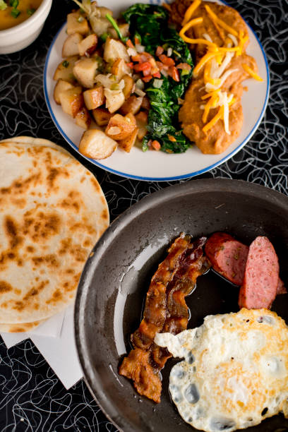 istock Steak and eggs. Classic American breakfast or brunch favorite. Filet & sunny side up eggs served with potato hash and fresh fruit. 1225556656