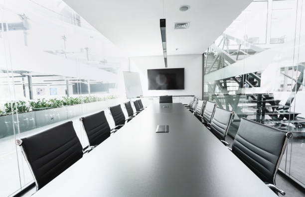 istock Long table in conference hall with TV, transparent walls 1225557656