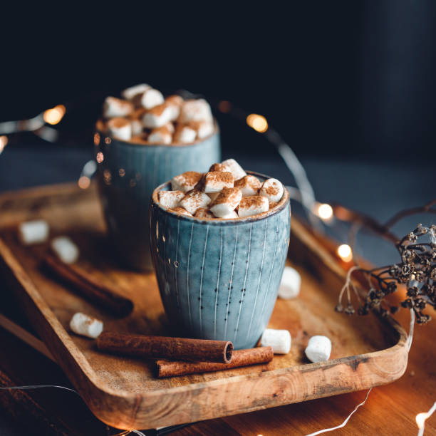 istock Hot chocolate with marshmallow and cinnamon in a blue ceramic cups on a table. The concept of cosy holidays and New Year. 1225557687