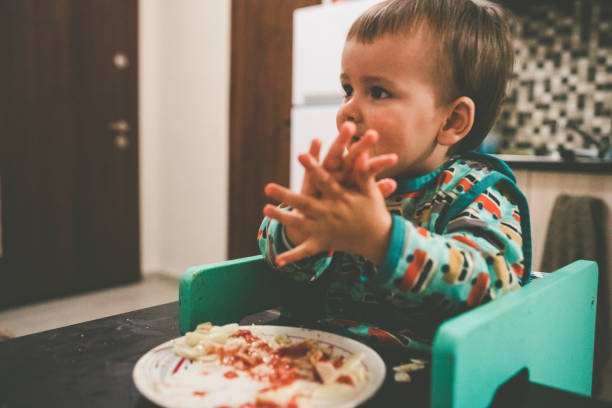 istock Cute baby eating pasta 1225558737