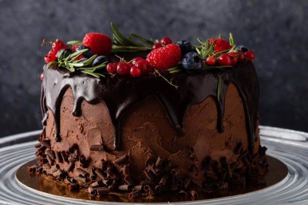 istock chocolate cake dessert with brown icing and fruits in rustic style 1225559039