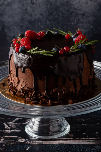 istock chocolate cake dessert with brown icing and fruits in rustic style 1225559041