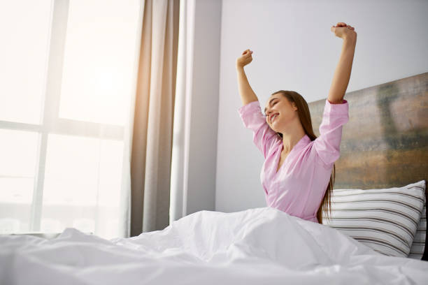 istock sleepy female on bed in weekends 1225559306