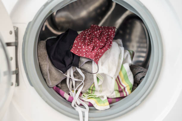 istock Face mask and dirty laundry in a washing machine, close-up 1225559822