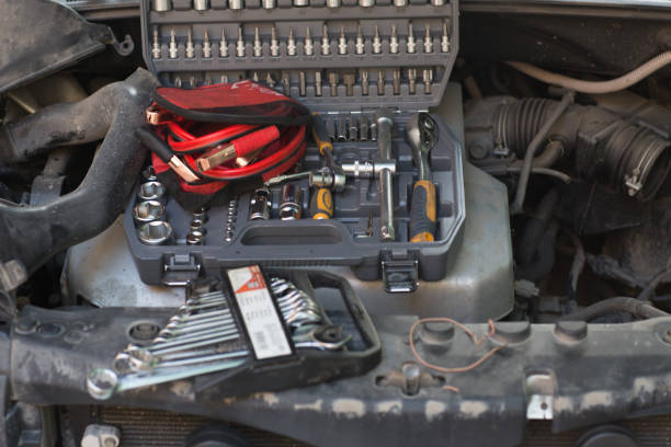 istock Car with open hood, set of keys and wires for ignition on engine 1225561064
