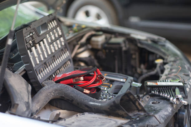 istock Car with open hood, set of keys and wires for ignition on engine 1225561072