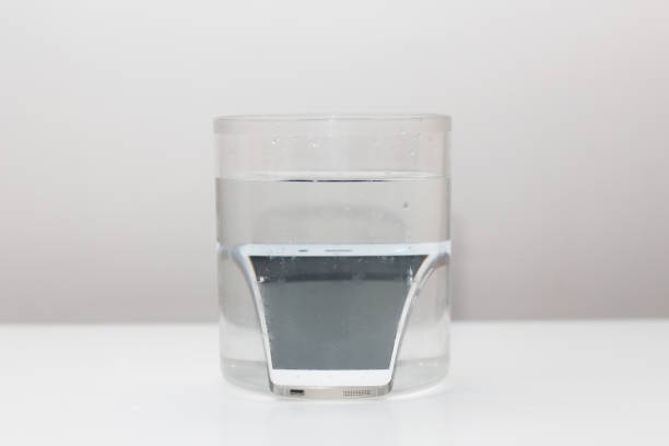 istock Mobile phone in vessel with water 1225561087