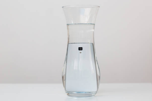istock Mobile phone in vessel with water 1225561120