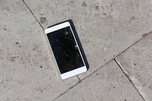 istock Cracked screen mobile phone lies on ground. 1225561163