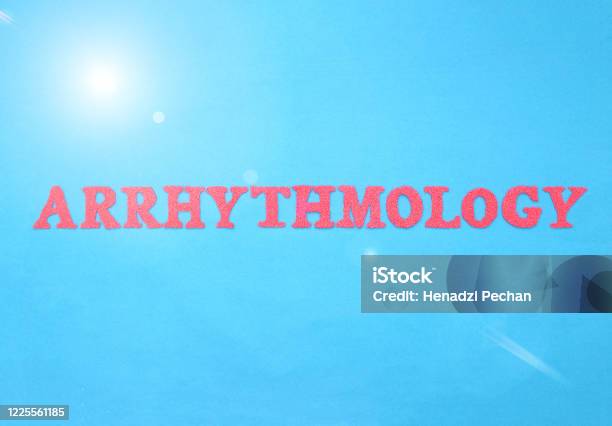 The Word Arrhythmology In Red Letters On A Blue Background Section Concept In Cardiology Dealing With The Treatment Of Heart Disease Arrhythmia Medicine Stock Photo - Download Image Now