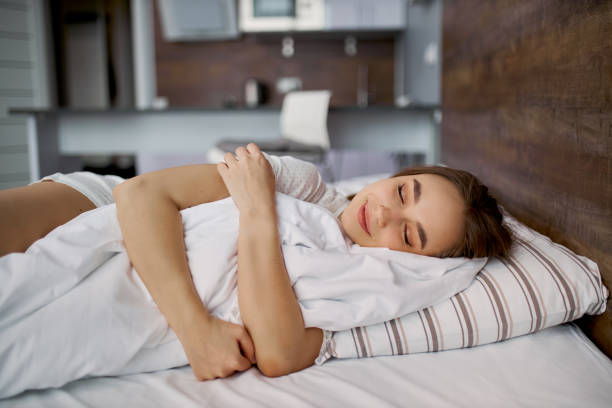 istock beautiful woman is hugging blanket while she is sleeping 1225561481