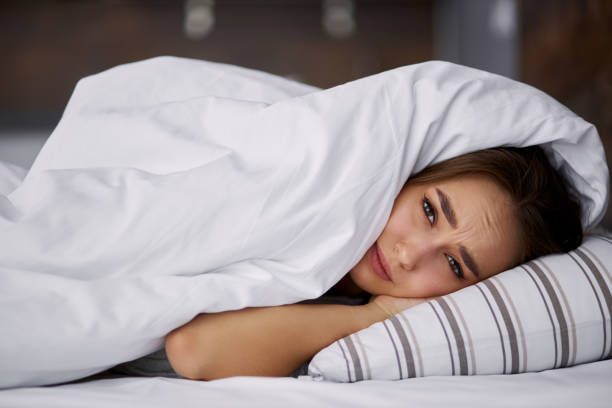 istock sad woman doesn't want to get up 1225561522