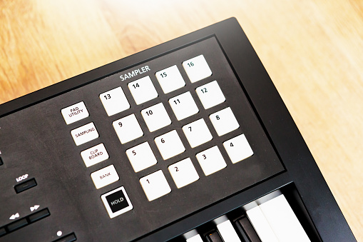 Digital midi keyboard (6.5 octaves) isolated on white.