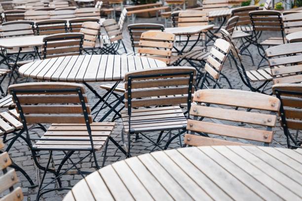 istock Empty street cafe, wooden tables and chairs 1225564746
