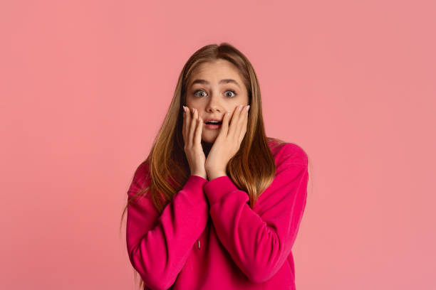 istock Scared girl covers her face with hands 1225567814