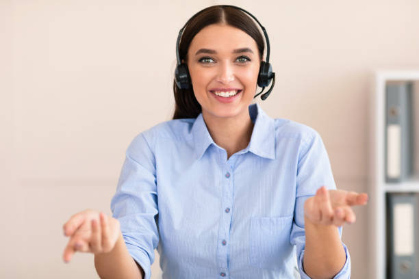 istock Cheerful Help Line Operator Girl In Headset Sitting In Office 1225567919