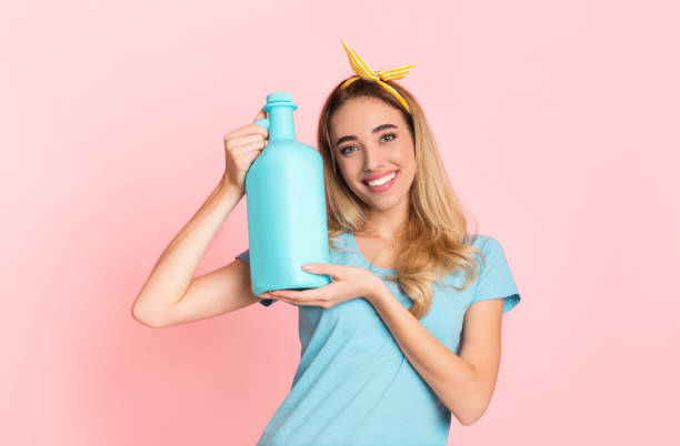istock Happy housewife holds fabric softener with empty space 1225571918