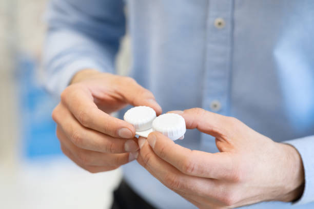 istock Young guy holding contact eye lenses container 1225572137