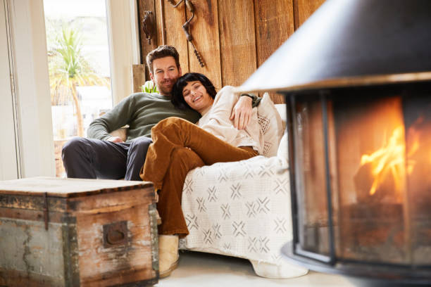 istock Smiling young couple relaxing by a fire in their cabin 1225572222