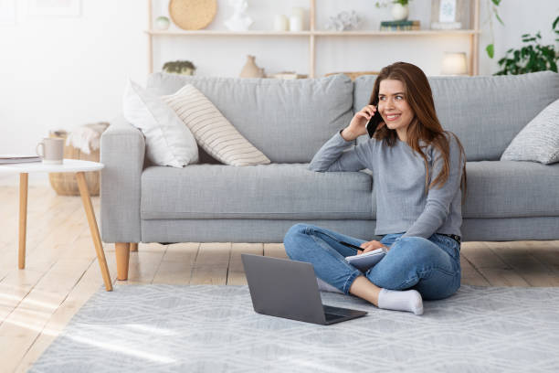 istock Woman freelancer working from home, talking with client on phone 1225572386