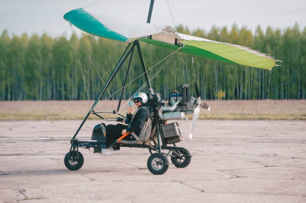 istock Pilot is using a smart phone and smiling while doing selfie in moto hang-glider 1225572831