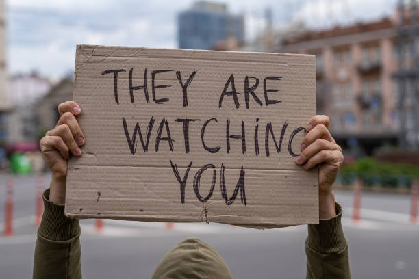 suspicious paranoid inscription of the person being pursued, stalking warning. suspicious paranoid inscription of the person being pursued, stalking warning. Ironic funny street art sign. Public social communication. Guy with sign social media inspiration. They are watching you political joke stock pictures, royalty-free photos & images