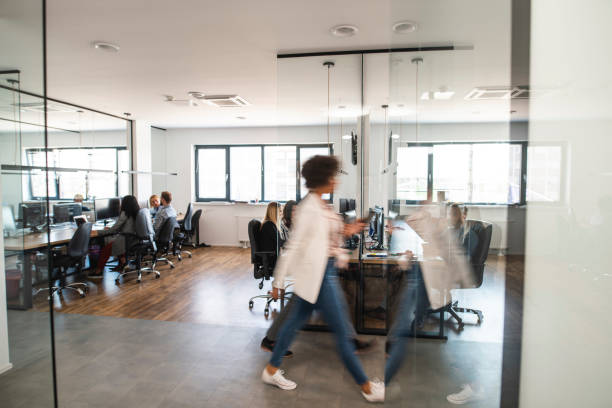 istock Young Businesswoman Walking Briskly Through Open Plan Office 1225576011