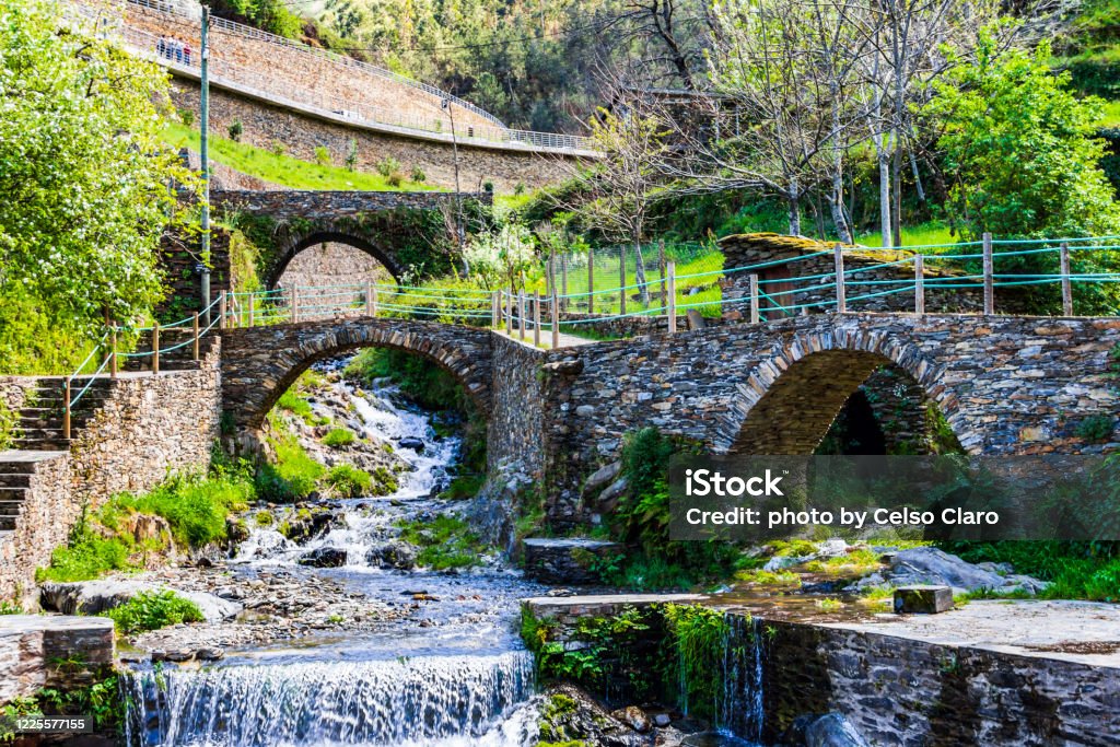 Park at Piódão, Portugal old bridge over the river with waterfall Portugal Stock Photo
