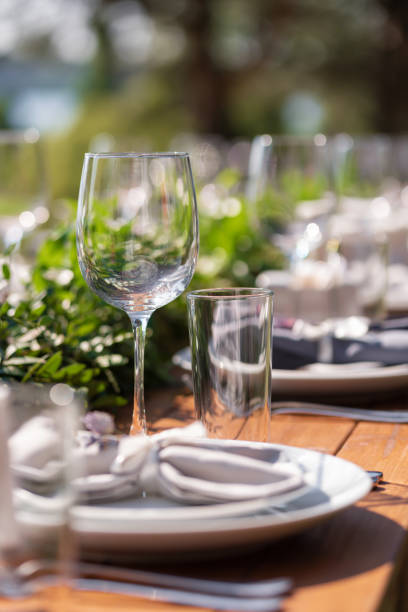 istock Preparing for an open-air party. Decorated with fresh flowers served tables. Table number. Decoration Details 1225577206