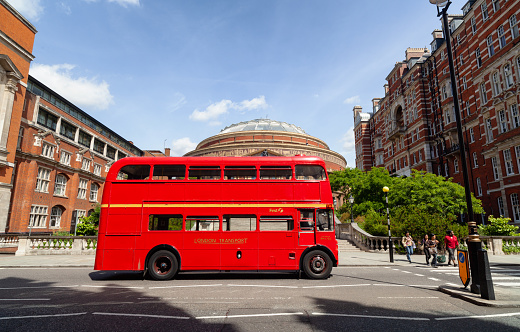 London, England - July 6, 2010: One of the few iconic Routemaster buses still running in London stopped at a zebra crossing in Prince Consort Road, in Kensington and Chelsea.