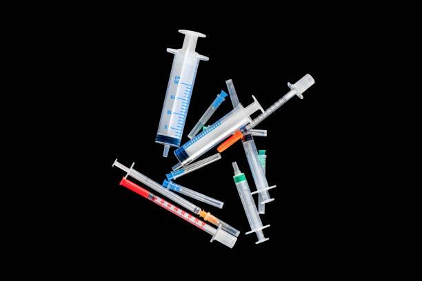 istock Many of different syringes on black background, isolated 1225579440