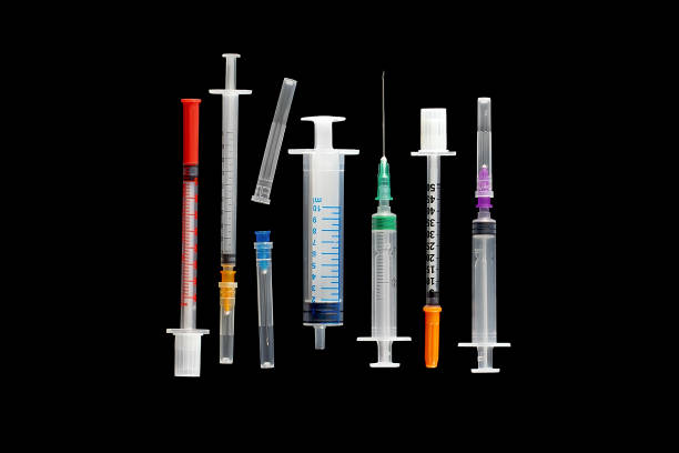 Collection of various syringes on black background, isolated