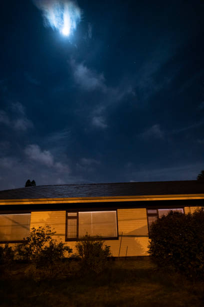 istock Full moon above exterior residential home 1225582947