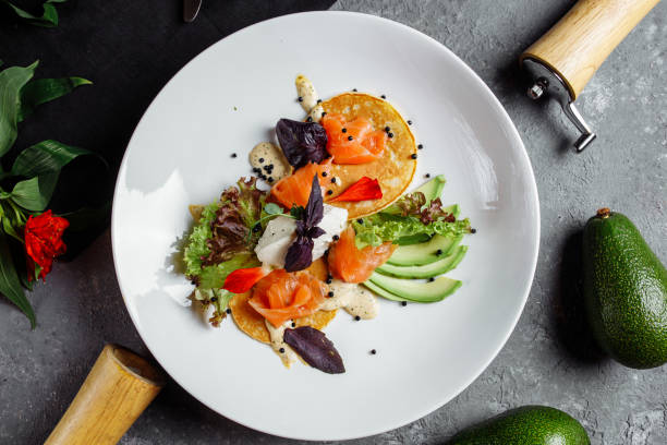 istock Green cupcakes with avocado and salmon, Pancake breakfast with avocado and salmon 1225583631