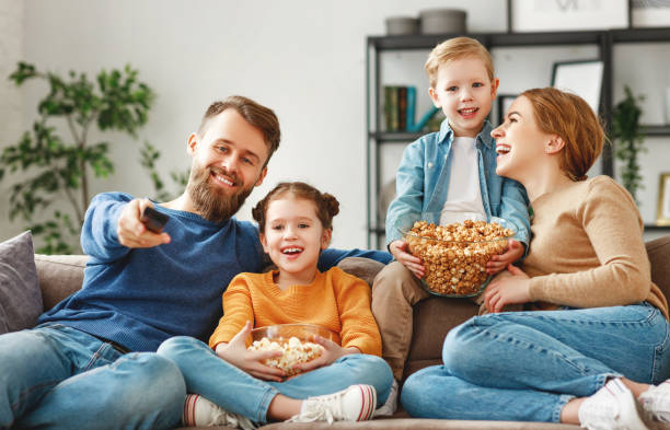 istock Joyful family resting on sofa together 1225584101