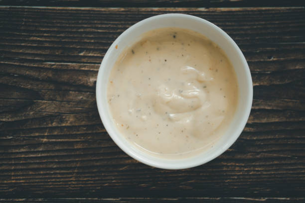 istock Caesar salad cream in a white bowl on wooden table 1225586953