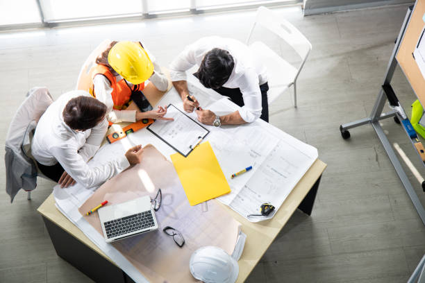 istock Three architects in the office and discussing design project on the table. 1225587098