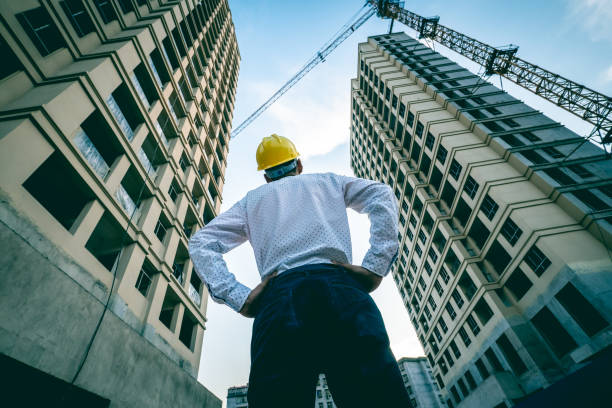 istock Engineer looking up the building he designed proudly 1225587425