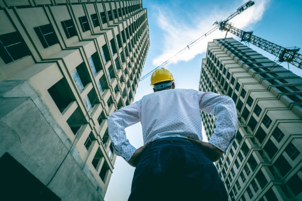 istock Engineer looking up the building he designed proudly 1225587428