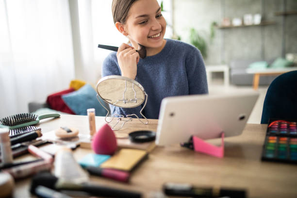 istock Bautiful Teenage girl watching DIY make up tutorial 1225587695