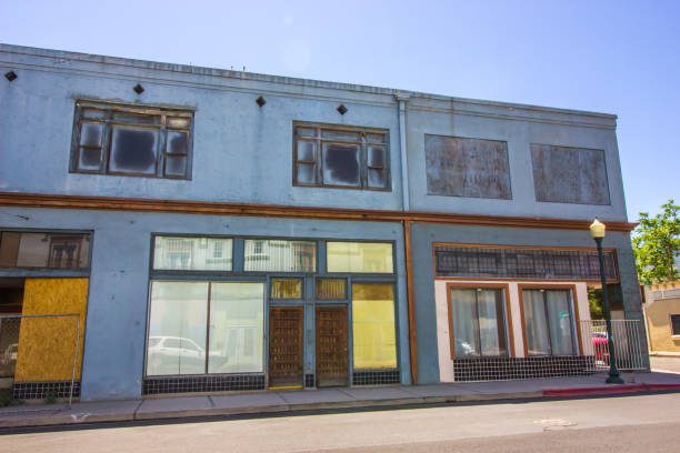 istock Row Of Closed Storefronts With Boarded Up Windows 1225589151